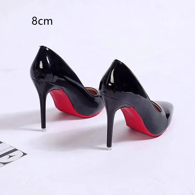 Fashionable women's black stiletto pumps with a sleek pointed toe design, formal footwear.