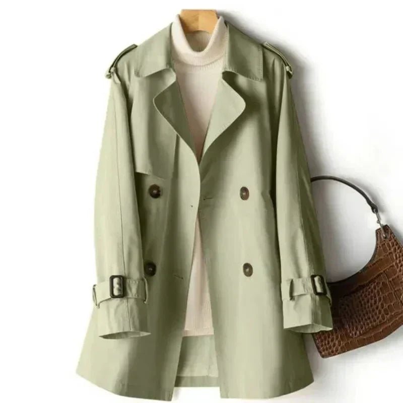 Formal women's belted trench coat featuring double-breasted front & adjustable cuffs. Classic office outerwear.