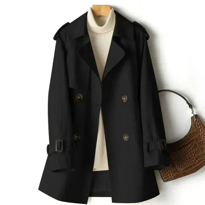 Women's belted double-breasted trench coat. Elegant classic outerwear with adjustable cuffs for office wear.