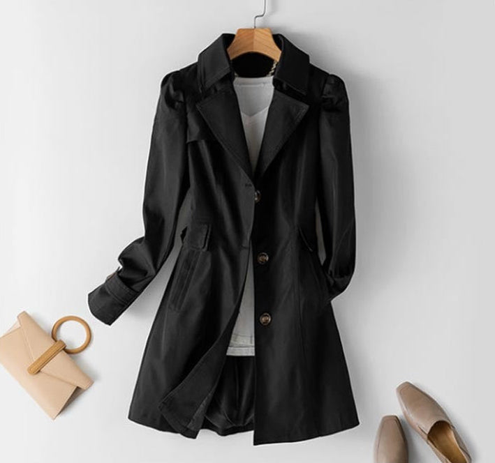 Chic women's structured trench coat with button closure. Essential long outerwear for professional spring & fall fashion.