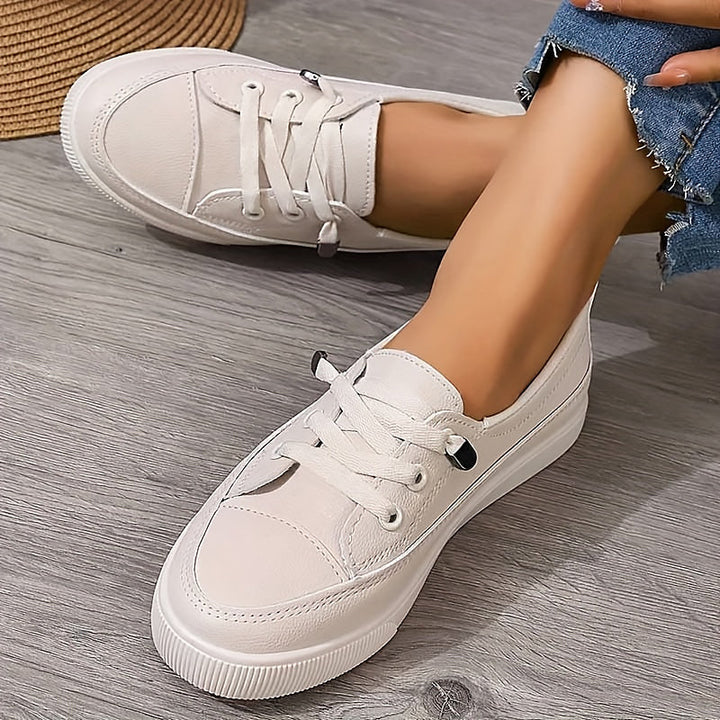 Women's classic white lace-up flatform sneakers. Comfortable, versatile casual court shoes for everyday style.