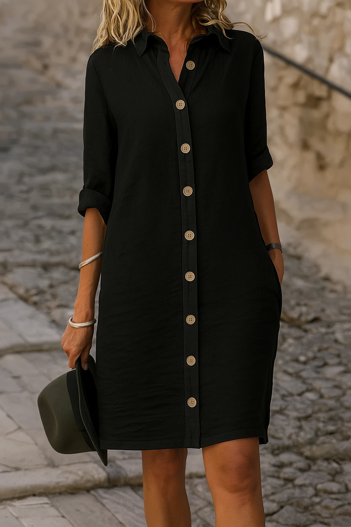 Women's collared button-front dress, roll-tab sleeves, comfortable for any casual summer outing.