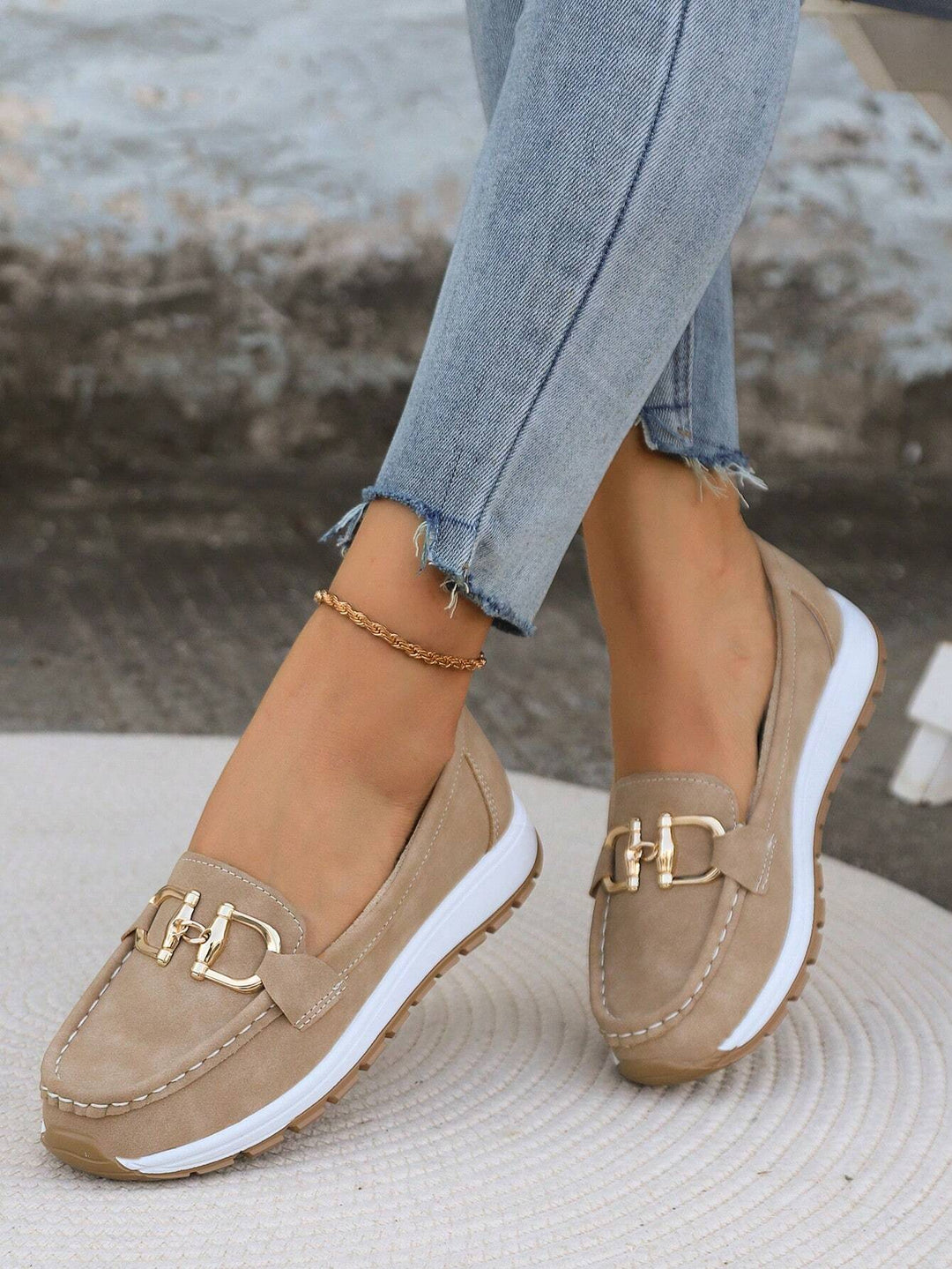Slip-on women's loafers featuring an elegant gold buckle, ideal for casual or office comfort.