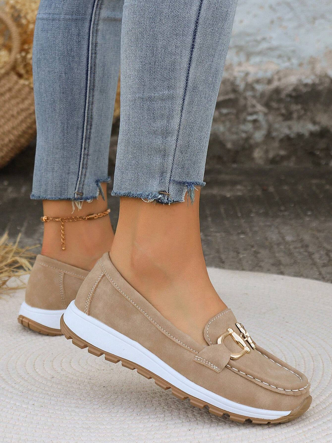 Women's gold buckle comfort loafers, designed for easy slip-on style and all-day wear.