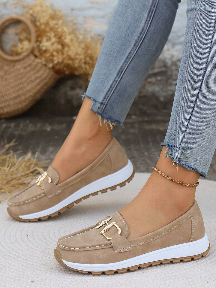 Elegant women's slip-on loafers featuring a stylish gold buckle, perfect for office or casual use.