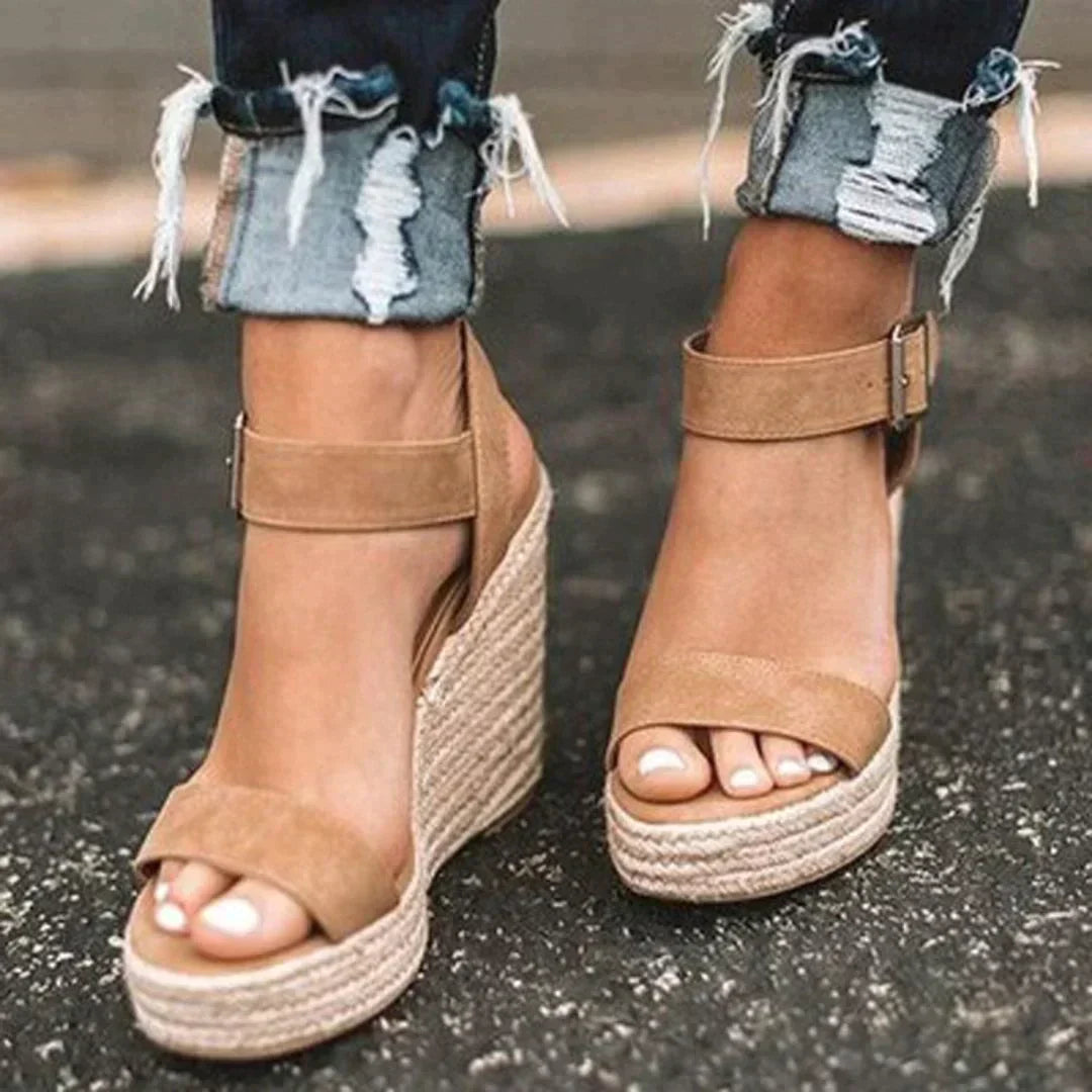 Women's comfortable brown woven wedge sandals, perfect for casual summer wear with an adjustable strap.