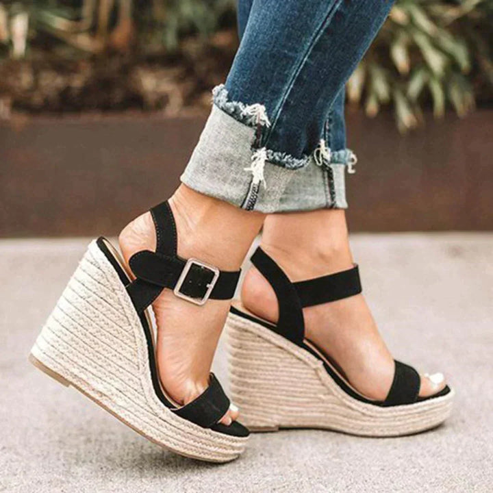 Chic black woven wedge sandals for women, offering elevated comfort and a stylish look for summer outfits.