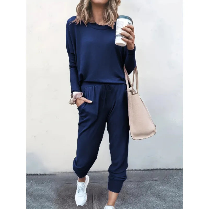 Complete women's two-piece jogger set featuring a crew neck long sleeve top and comfortable tapered pants.