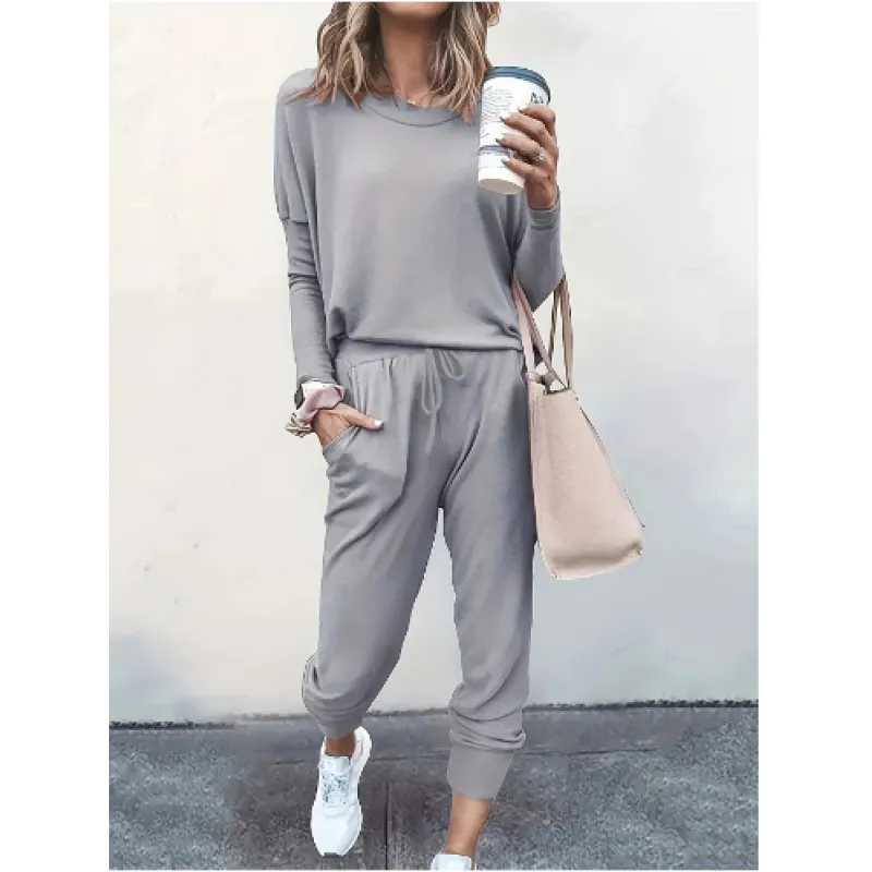 Active women's crew neck jogger set. Stylish two-piece casual outfit with long sleeve top & tapered pants.