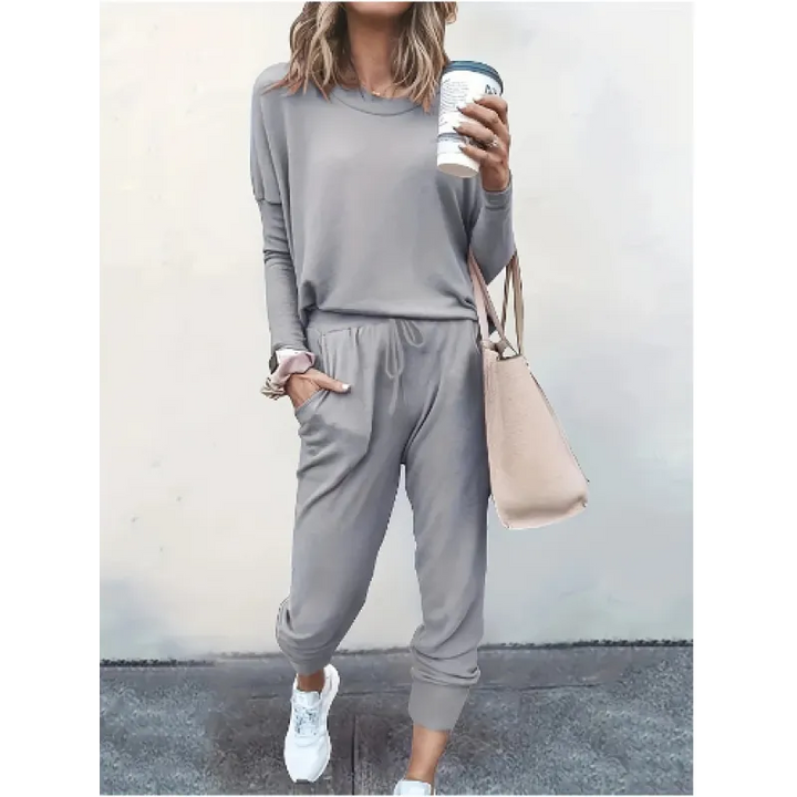 Active women's crew neck jogger set. Stylish two-piece casual outfit with long sleeve top & tapered pants.