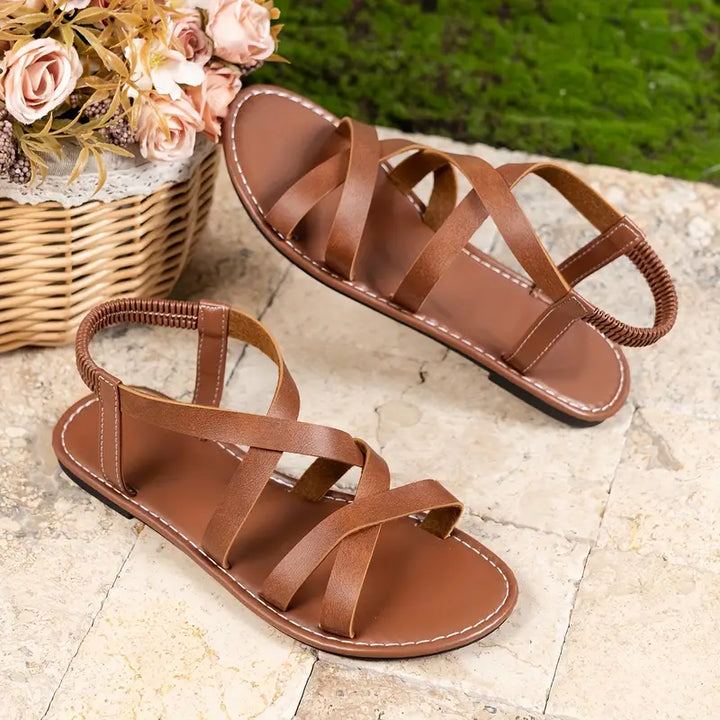 Durable women's criss-cross flat Roman sandals for active summer days, comfortable & trendy.