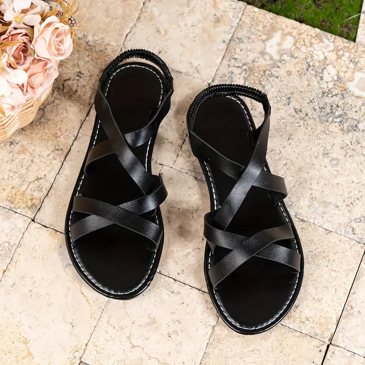 Open-toe women's summer sandals, featuring comfortable criss-cross Roman flat design.