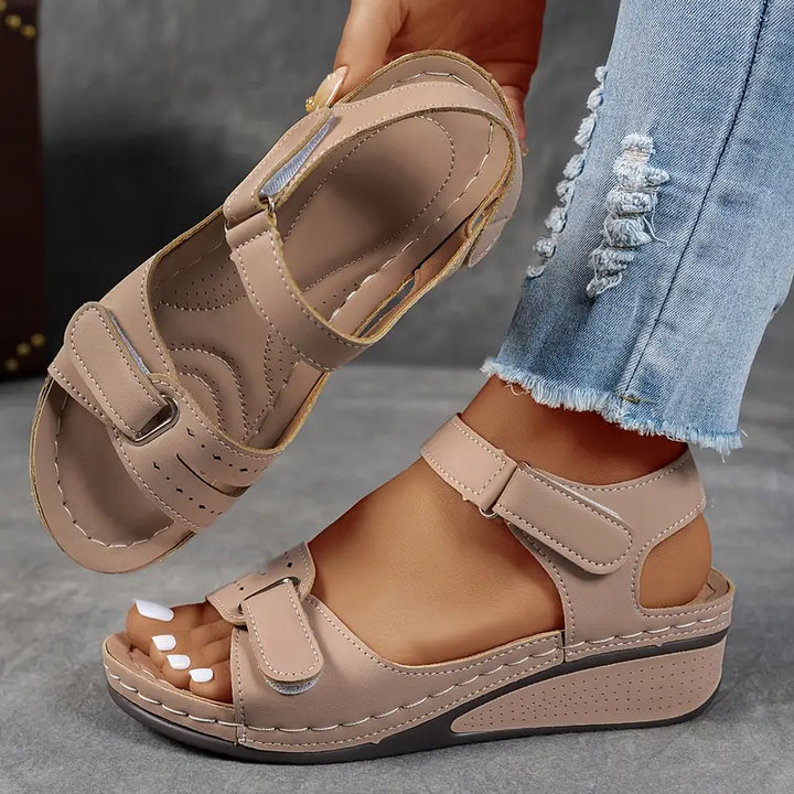 Comfortable women's wedge sandals with a cushioned footbed and adjustable straps for casual wear.
