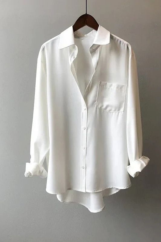 Stylish blue flowy blouse for women. Versatile and comfortable, ideal for casual or office wear.