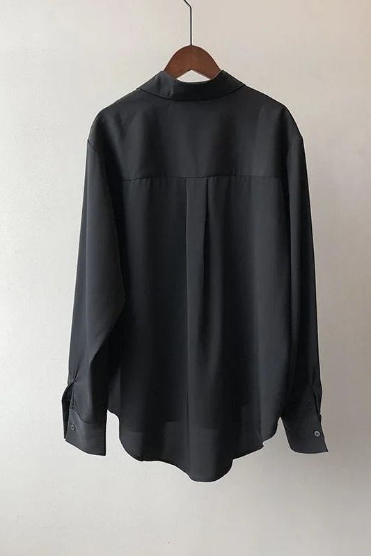 Black flowy blouse for women, offering a comfortable and elegant look. Perfect for office or casual chic.