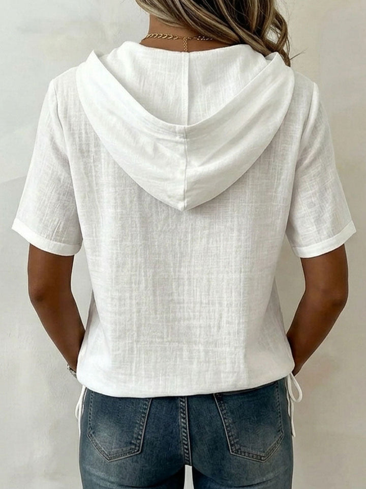Stylish women's long-sleeve hooded shirt. Versatile design with a button-up front for modern casual looks.