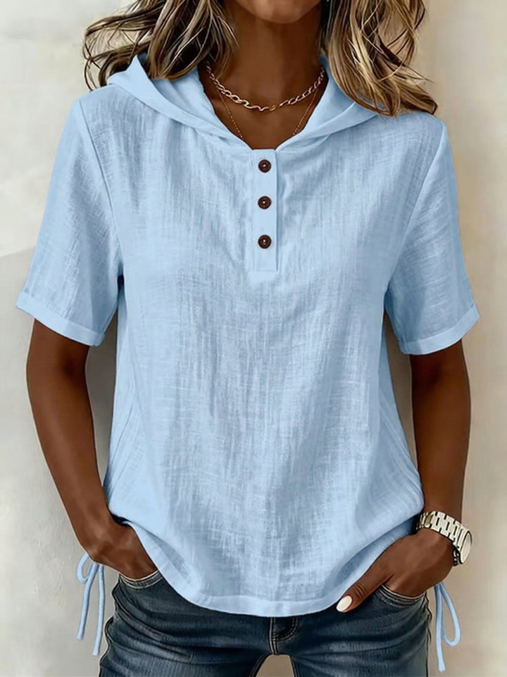 Casual women's hooded shirt with a comfortable relaxed fit. Stylish long-sleeve top for everyday wear.