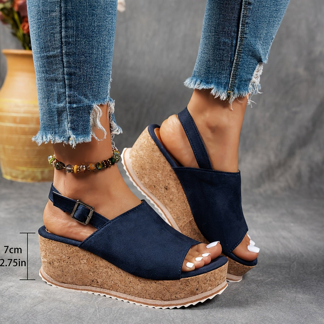 Close-up of women's leopard print wedge sandals, highlighting the comfortable platform and buckle.