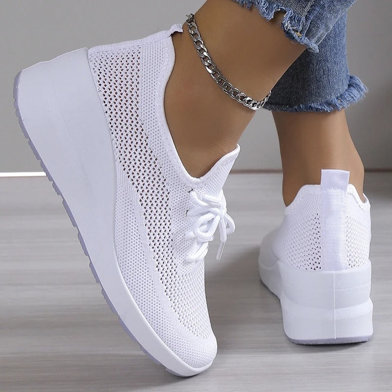 Chic ladies' platform wedge sneakers, combining comfort, athletic appeal, & height-enhancing style.