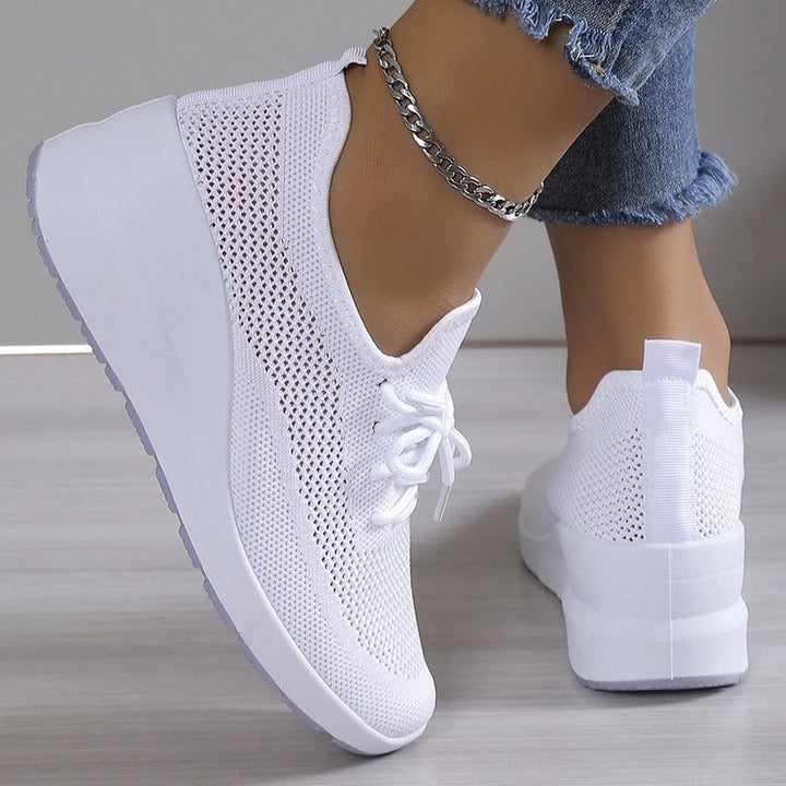 Chic ladies' platform wedge sneakers, combining comfort, athletic appeal, & height-enhancing style.