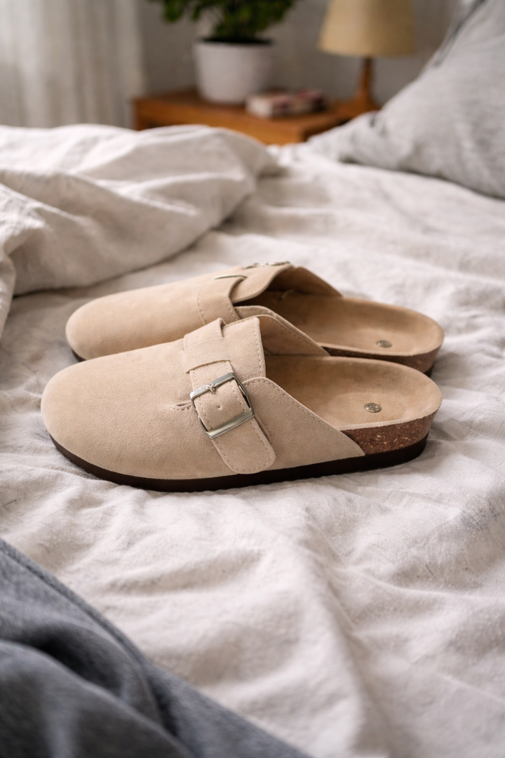 Casual women's clogs featuring a comfortable design and practical buckle strap for easy slip-on wear.