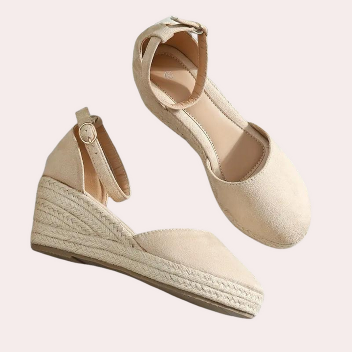 Chic women's Alina wedge sandals with a secure adjustable ankle strap for elegant summer outfits.