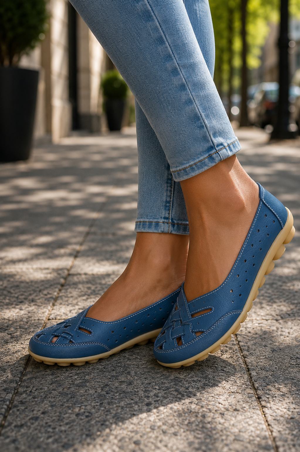 Elegant women's white slip-on ballet flats with a round toe, ideal for versatile casual or work wear.