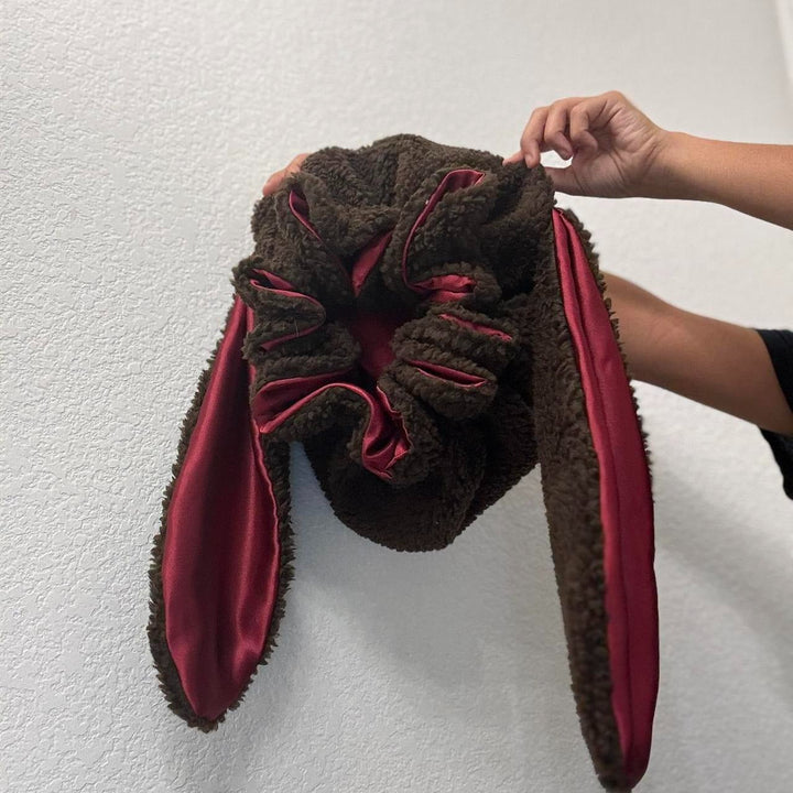 Soft women's sleep bonnet, a cozy bunny hat offering hair protection & warmth, plush winter accessory.