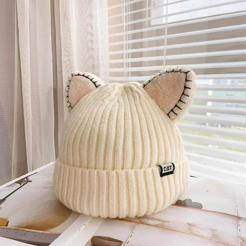 Women's cozy knitted winter hat with cute cat ears. Perfect warm accessory for cold weather fashion.