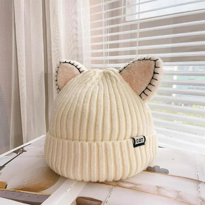 Women's cozy knitted winter hat with cute cat ears. Perfect warm accessory for cold weather fashion.