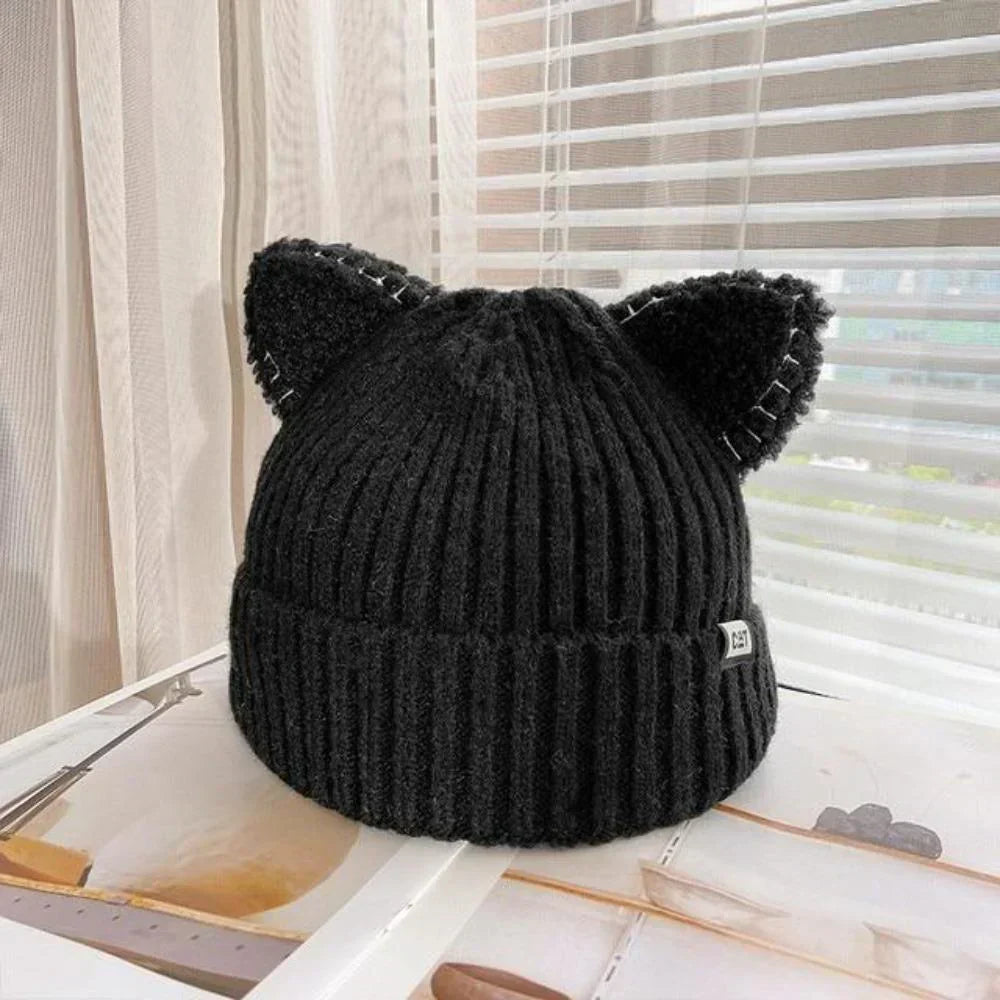Playful women's knitted cat ear beanie. Soft, warm winter hat for a cute and cozy cold-weather look.