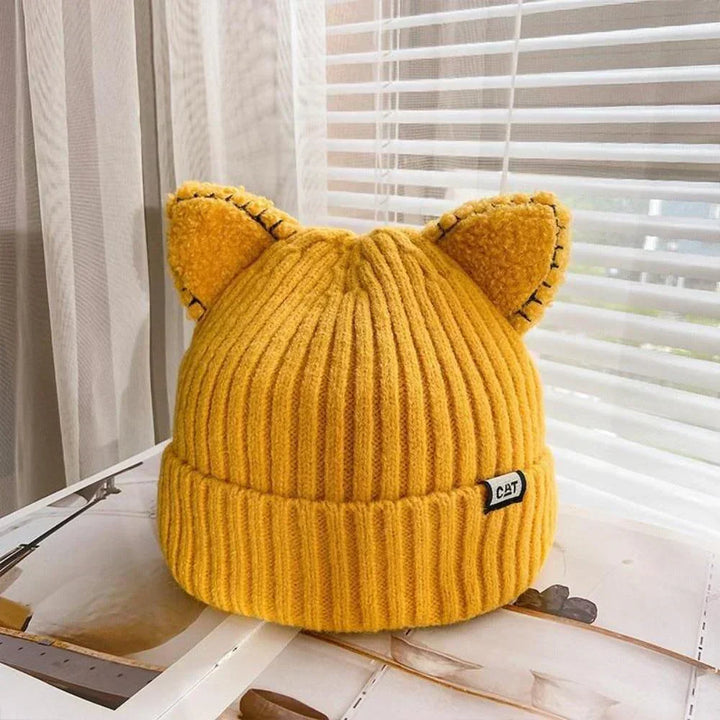 Cute women's cat ear knitted beanie. A cozy, soft winter hat, perfect for playful cold-weather fashion.