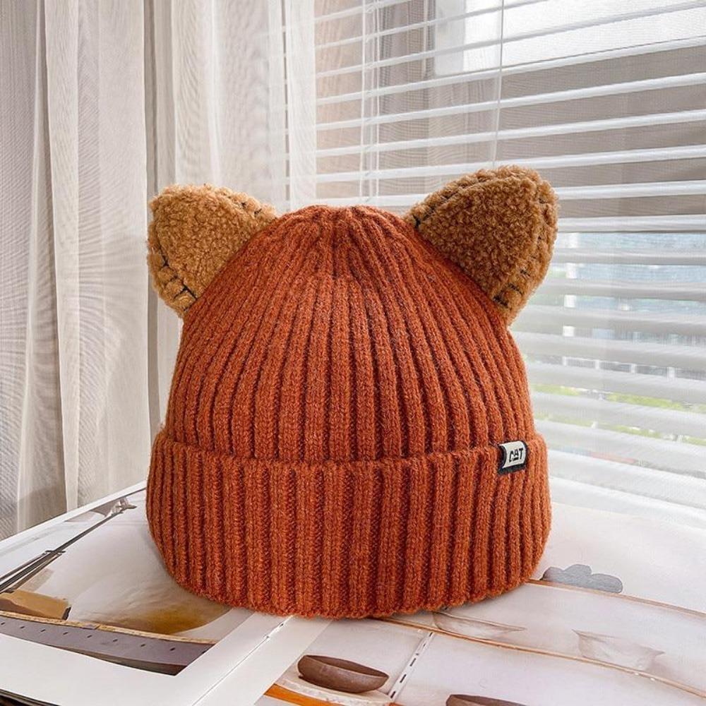 Fashionable women's knitted cat ear hat. Warm, cozy winter accessory with a playful design for cold days.