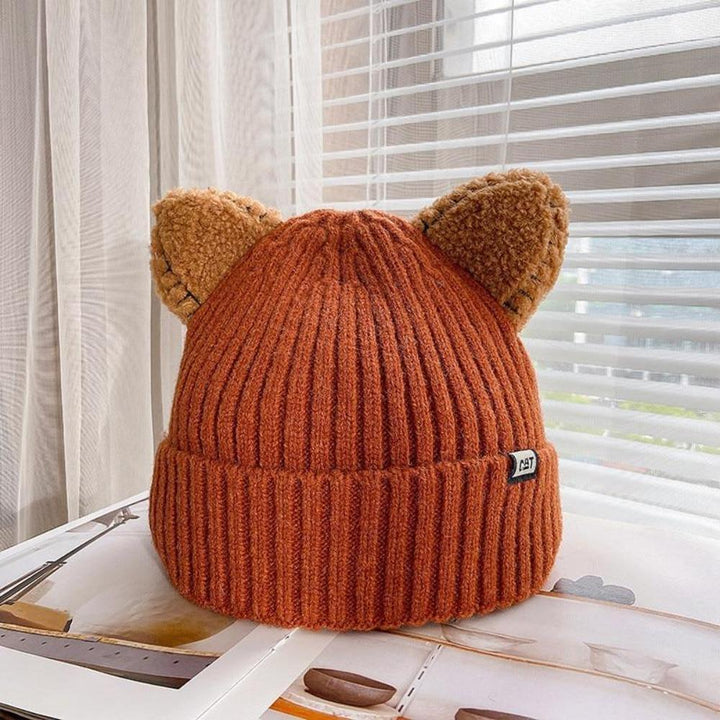 Fashionable women's knitted cat ear hat. Warm, cozy winter accessory with a playful design for cold days.