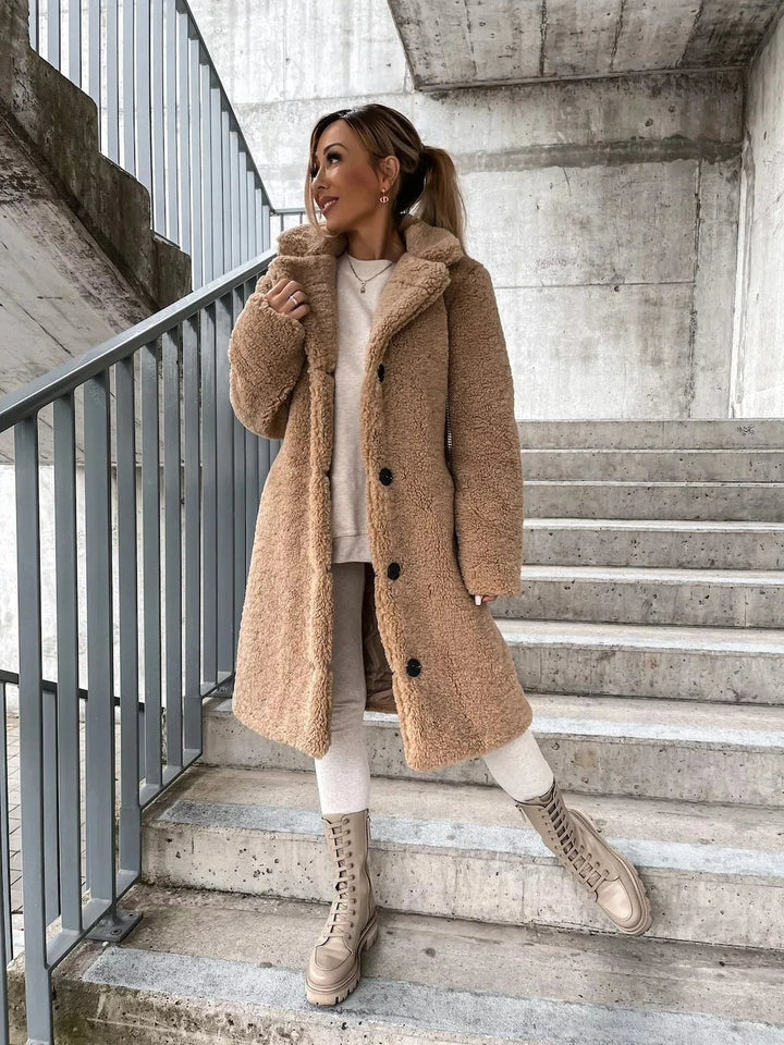 Women's cozy longline teddy coat, soft faux fur for warmth and style.