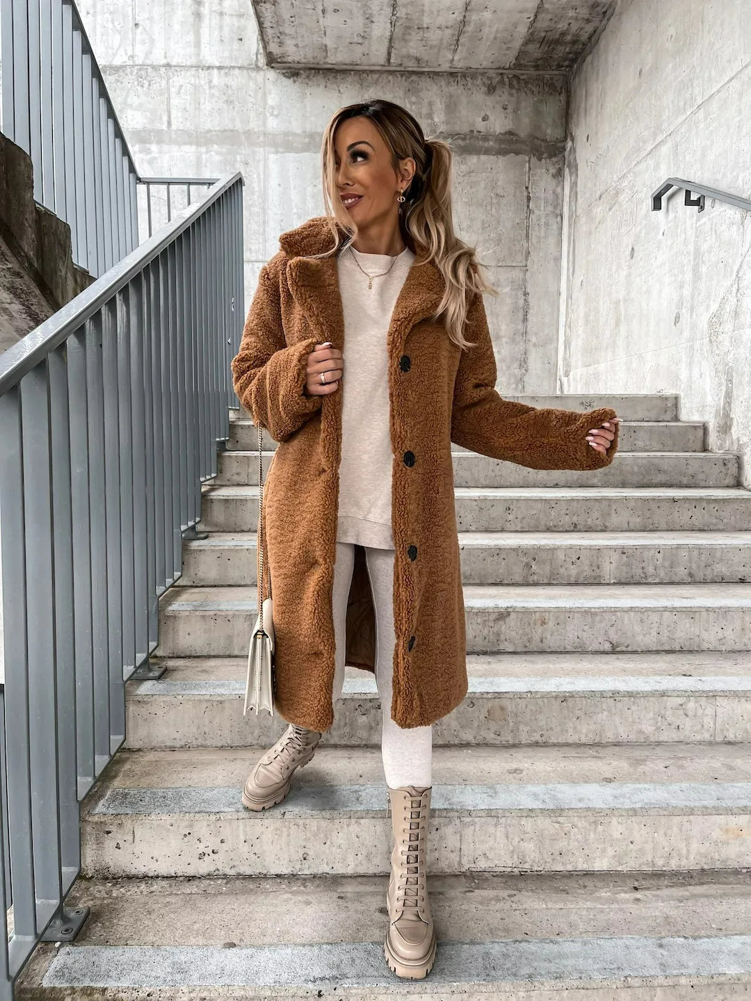 Cozy women's teddy longline coat in a modern trench style, perfect for fall fashion.