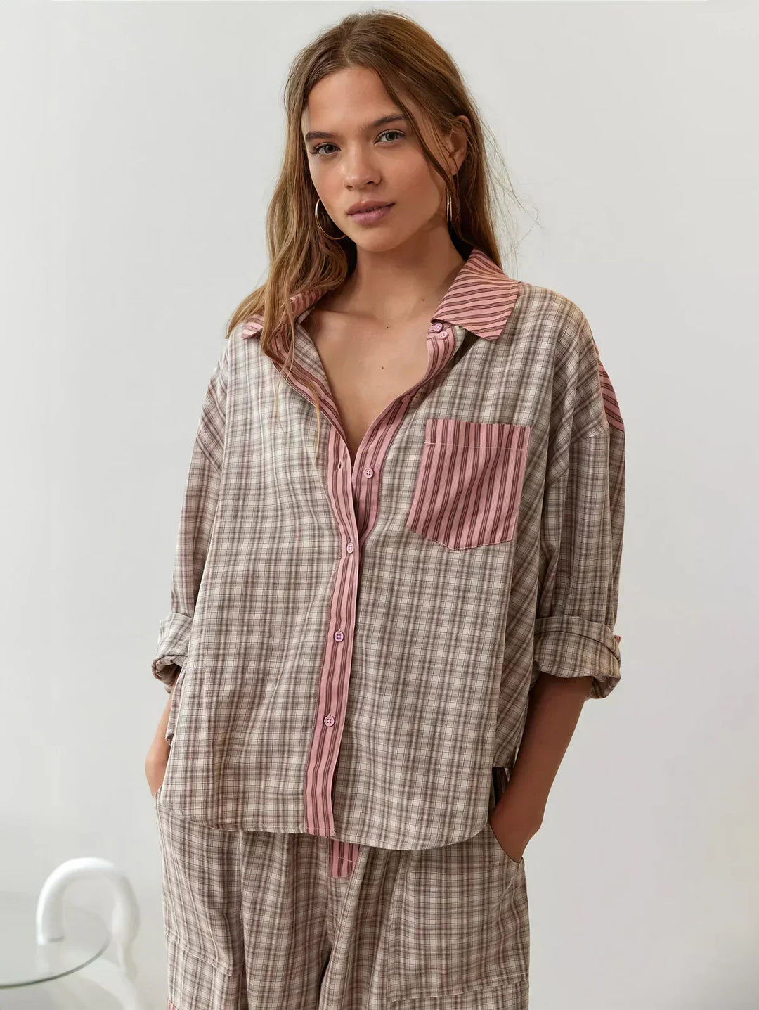 Women's cozy pink plaid button-up pajama set. Relaxed fit 2-piece sleepwear for ultimate comfort.