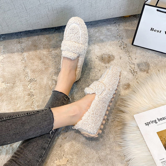 Warm slip-on women's loafer slippers, plush and comfortable, perfect as indoor house shoes for relaxation.