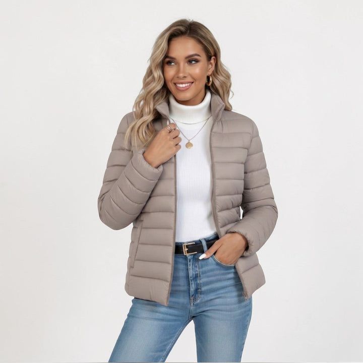 Women's cozy quilted jacket with stand collar & full zip closure, perfect for winter fashion.