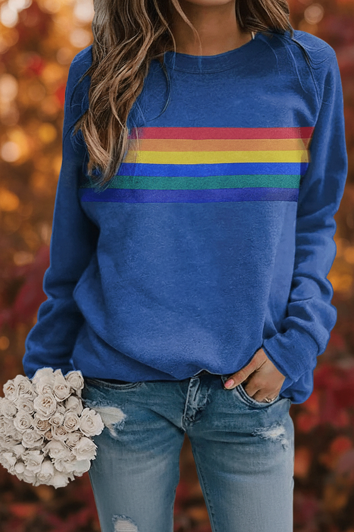 Stylish women's rainbow striped long sleeve pullover, offering cozy comfort and a trendy retro fashion vibe.