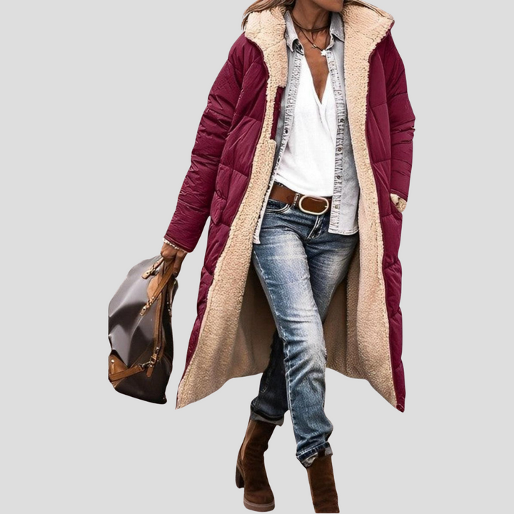 Women's reversible hooded winter coat, offering two stylish looks & cozy warmth for cold weather.