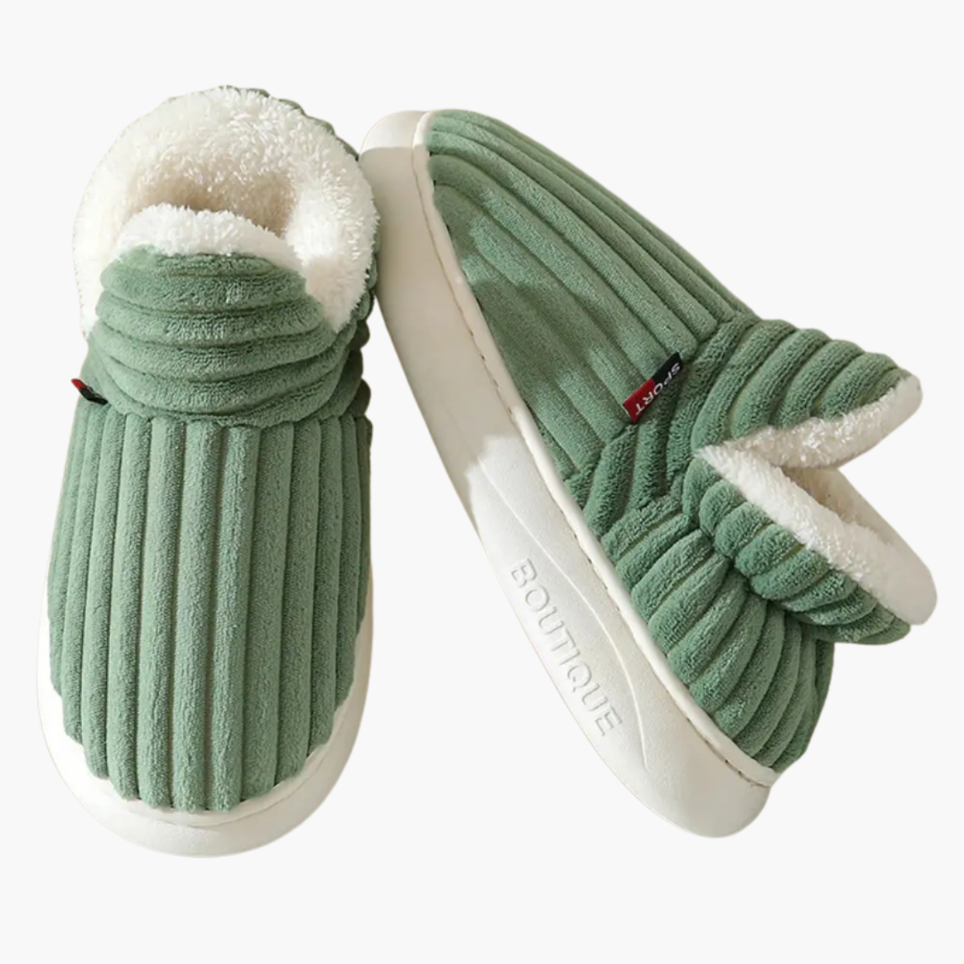 Warm women's ribbed bootie slippers with plush lining. Cozy slip-on indoor footwear for fall & winter comfort.