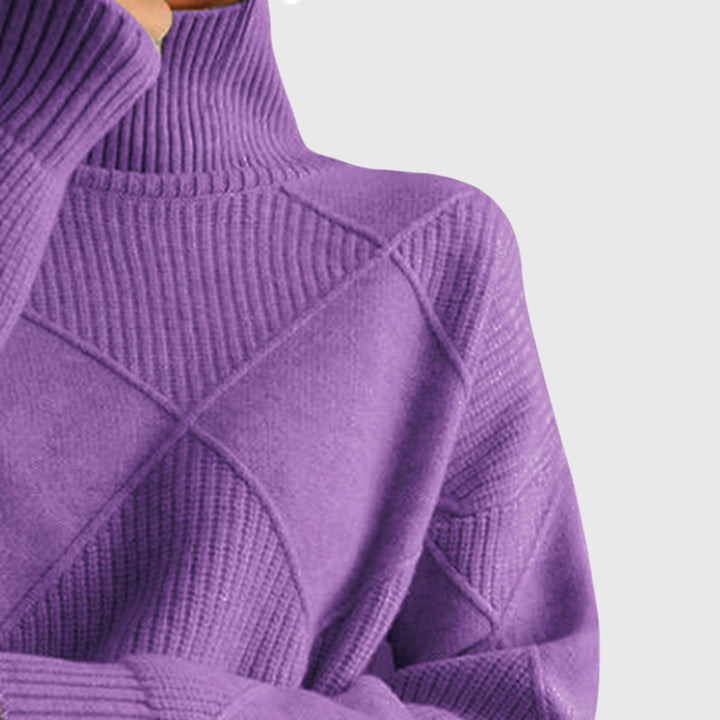Relaxed fit women's knit sweater, featuring a cozy roll neck and drop shoulder sleeves.