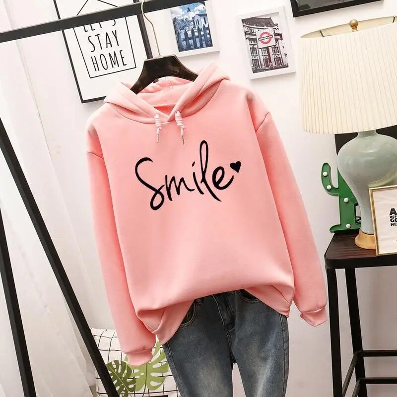 Soft women's smile graphic pullover hoodie in a cozy fit. Ideal for casual comfort & everyday positive fashion.