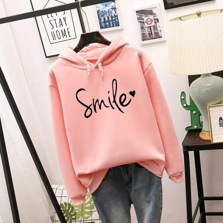 Soft women's smile graphic pullover hoodie in a cozy fit. Ideal for casual comfort & everyday positive fashion.