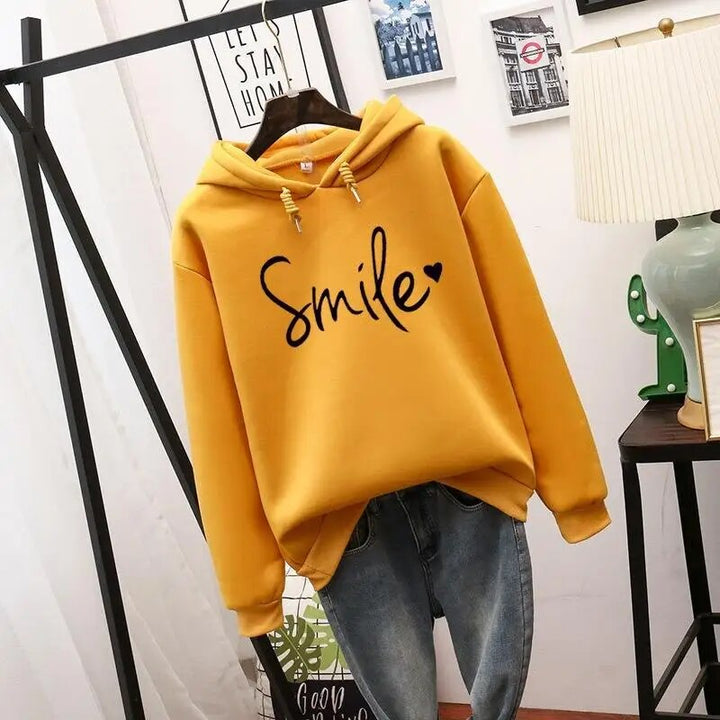 Comfortable women's cozy hoodie featuring a positive smile graphic. A casual long sleeve pullover for daily style.