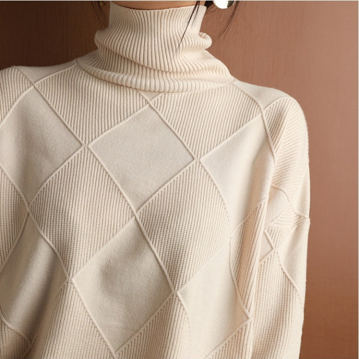 Relaxed fit women's turtleneck knit pullover, embodying effortless autumn and winter style.