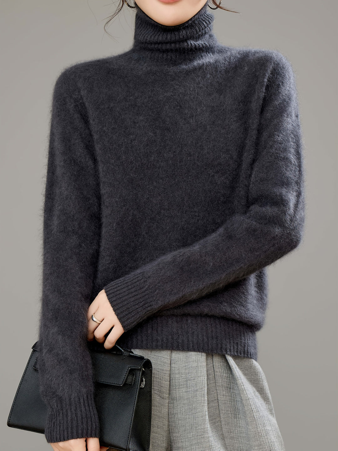Long-sleeve women's cozy turtleneck sweater, essential warm clothing for stylish winter comfort.