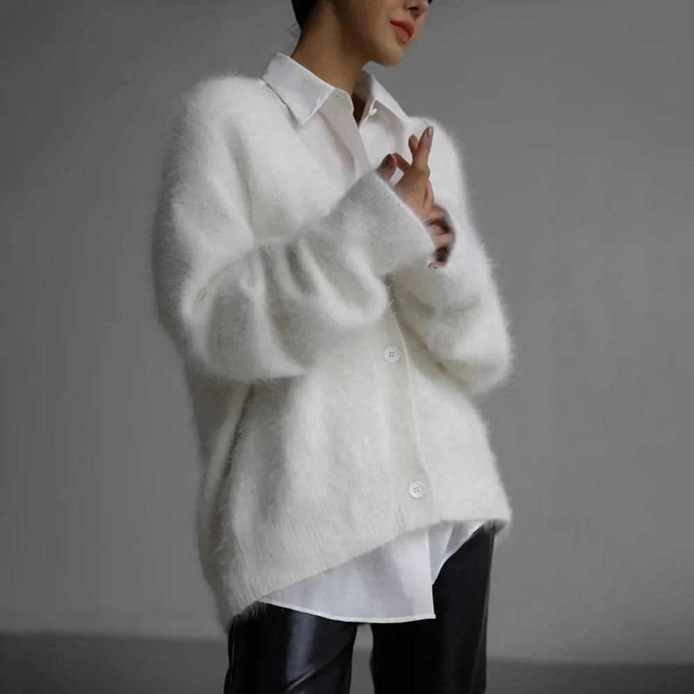 Relaxed fit women's v-neck cardigan, ideal for fall fashion. Cozy button-front outerwear, soft knit for comfort.