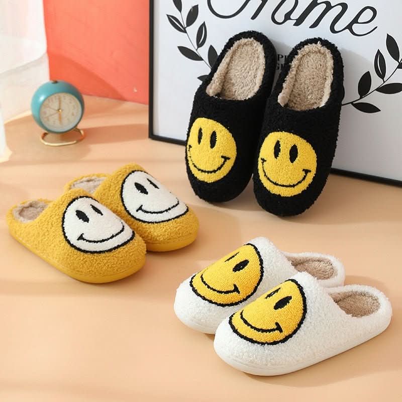 Comfortable women's winter footwear: plush smiley slippers with a warm lining and a durable non-slip sole.